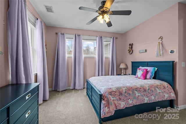 bedroom with visible vents, light carpet, baseboards, and ceiling fan