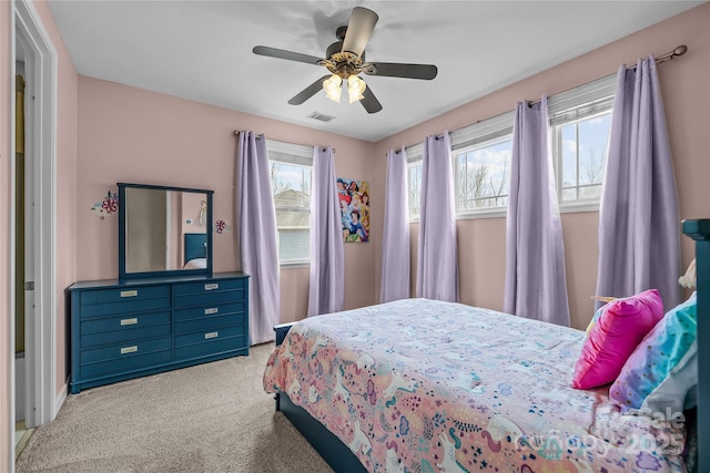 carpeted bedroom featuring visible vents and a ceiling fan