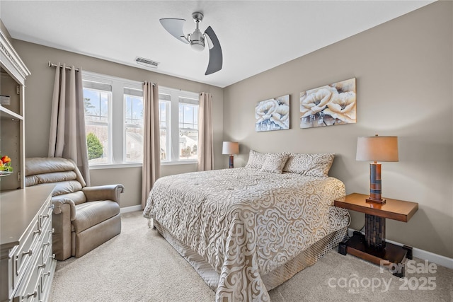 bedroom with visible vents, baseboards, light colored carpet, and ceiling fan