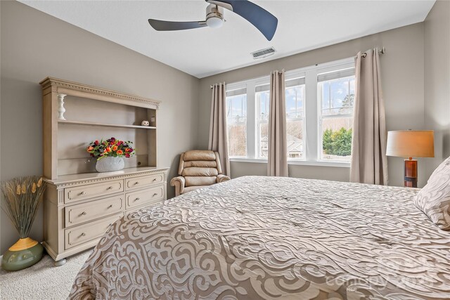 bedroom featuring visible vents, ceiling fan, and carpet