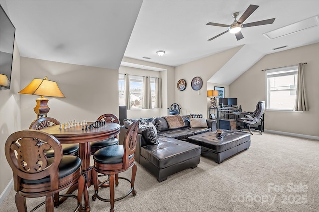 carpeted living room featuring visible vents, lofted ceiling, baseboards, and a ceiling fan