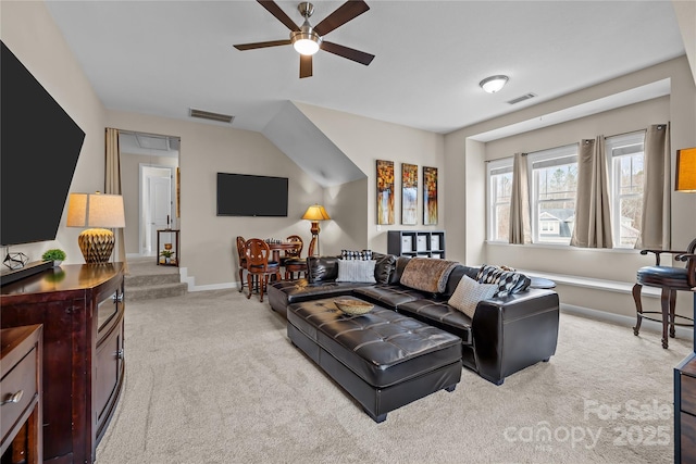 carpeted living area featuring visible vents, ceiling fan, attic access, and baseboards