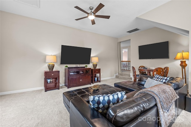 living room featuring visible vents, carpet floors, baseboards, and a ceiling fan