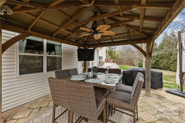 view of patio featuring a gazebo, outdoor dining space, and fence