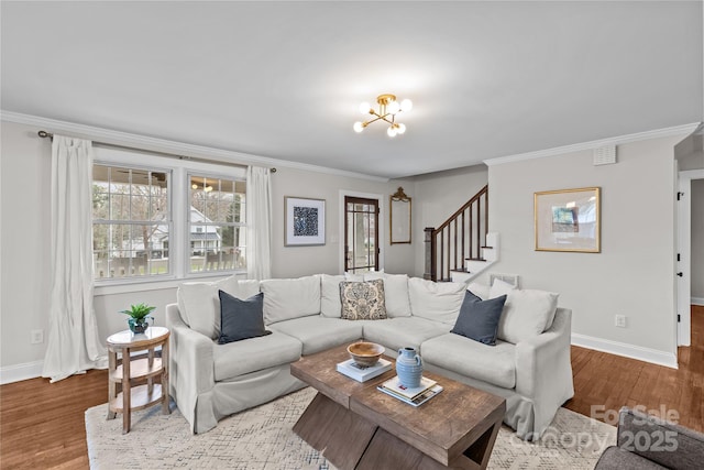 living area featuring an inviting chandelier, wood finished floors, and ornamental molding