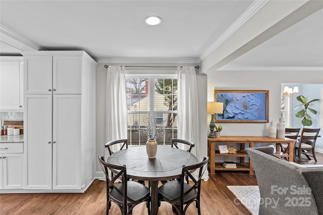 dining area with recessed lighting, a notable chandelier, wood finished floors, and crown molding