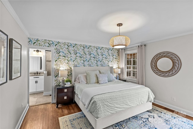 bedroom with wallpapered walls, crown molding, baseboards, and a sink