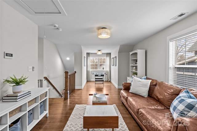 living room with attic access, baseboards, visible vents, and dark wood-style flooring