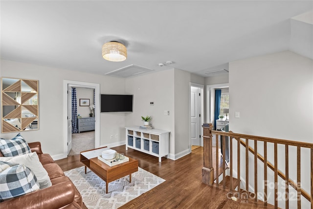 living room with baseboards, attic access, and wood finished floors