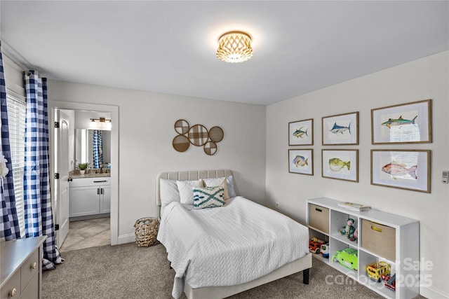 bedroom featuring light colored carpet and ensuite bath