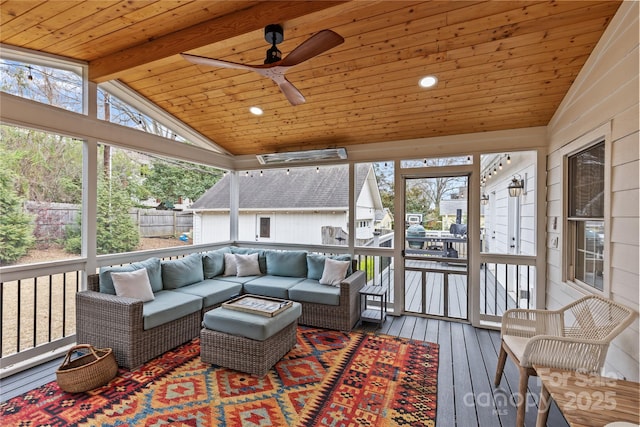 sunroom featuring wood ceiling, lofted ceiling with beams, and a ceiling fan