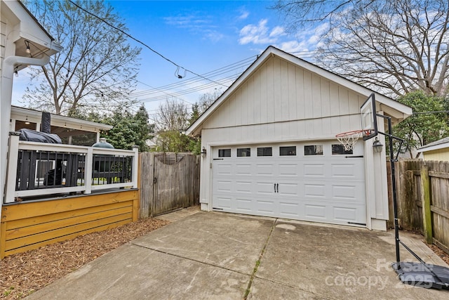 detached garage with a gate and fence