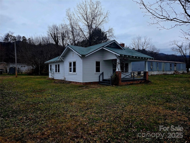 view of property exterior with a yard and a chimney