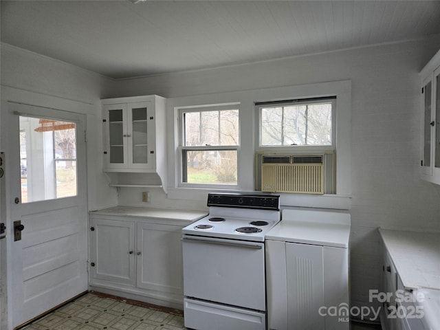 kitchen featuring a healthy amount of sunlight, white cabinetry, electric stove, and light countertops