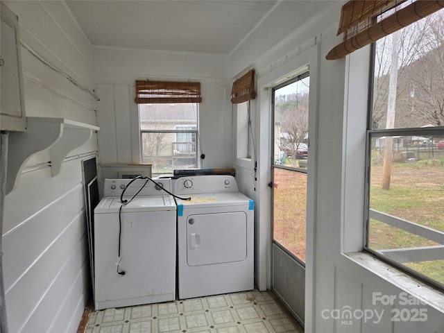 laundry area featuring laundry area, light floors, and washer and clothes dryer