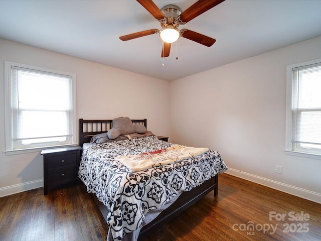 bedroom featuring ceiling fan, baseboards, and wood finished floors