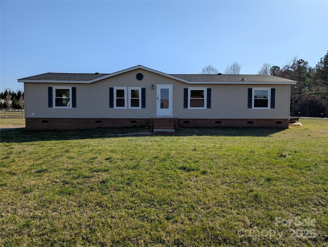 manufactured / mobile home with crawl space, a shingled roof, a front lawn, and fence