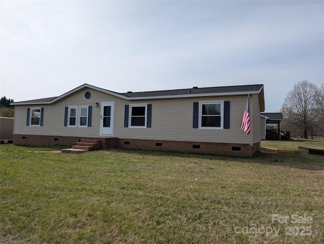 manufactured / mobile home featuring crawl space, entry steps, and a front lawn