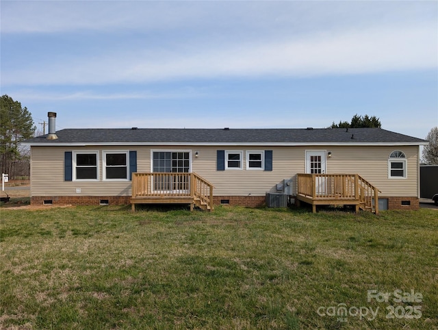 rear view of house with crawl space, a lawn, and a deck