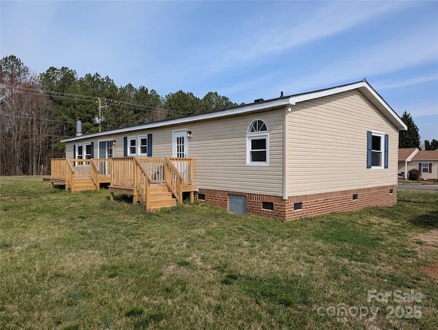 back of property with a wooden deck, a lawn, and crawl space