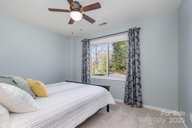 bedroom with visible vents, baseboards, carpet, and a ceiling fan