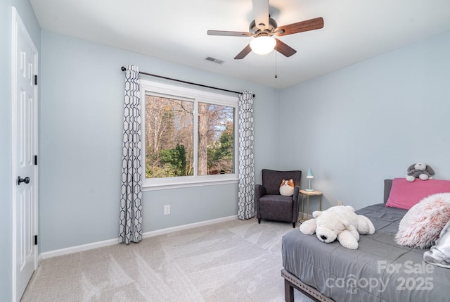 carpeted bedroom featuring visible vents, a ceiling fan, and baseboards