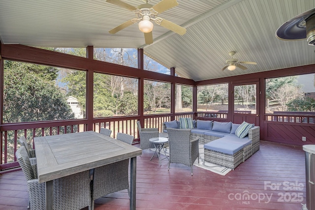 sunroom / solarium with vaulted ceiling and a ceiling fan