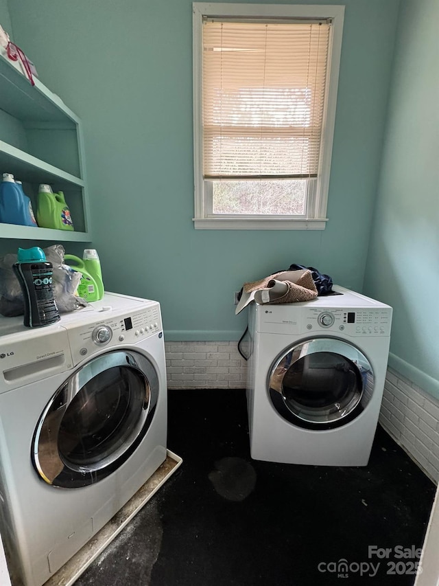 clothes washing area featuring laundry area and washing machine and clothes dryer