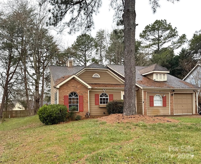 view of front of house with fence, roof with shingles, a front lawn, a garage, and brick siding