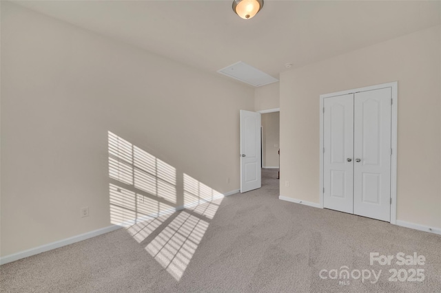 unfurnished bedroom with a closet, carpet flooring, and baseboards