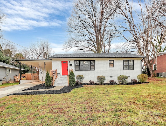 view of front of home with driveway, a front yard, crawl space, a carport, and brick siding