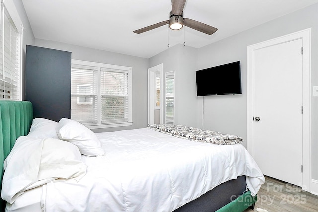 bedroom with light wood-style flooring and a ceiling fan