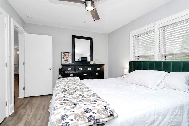 bedroom with ceiling fan and wood finished floors