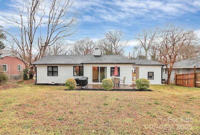 back of property with a yard, a patio, brick siding, and a fenced backyard