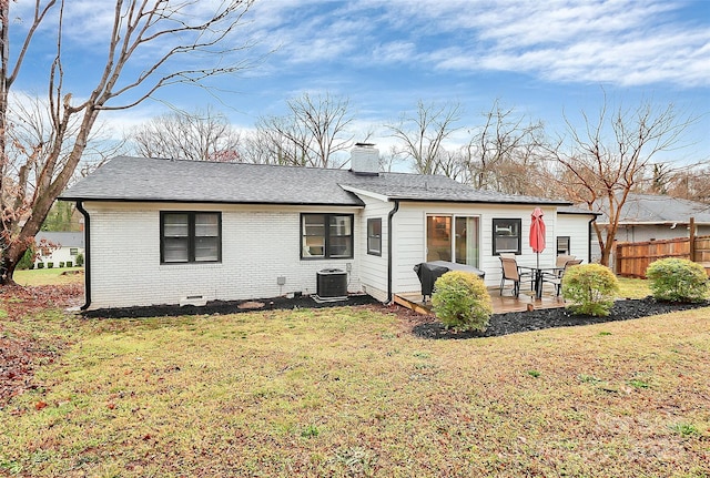 rear view of property featuring central air condition unit, a patio, fence, brick siding, and a chimney