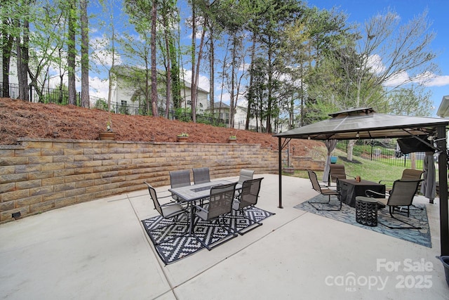 view of patio with outdoor dining area, a gazebo, and fence
