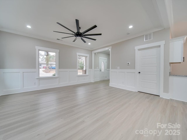 unfurnished living room with visible vents, light wood-style flooring, ornamental molding, recessed lighting, and ceiling fan