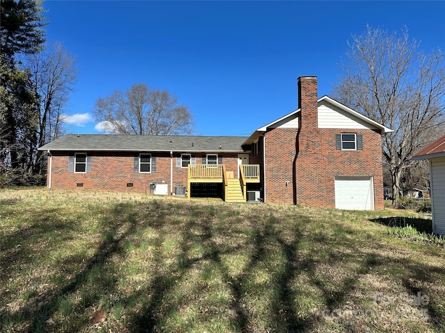 rear view of house featuring a wooden deck, a chimney, a garage, crawl space, and brick siding