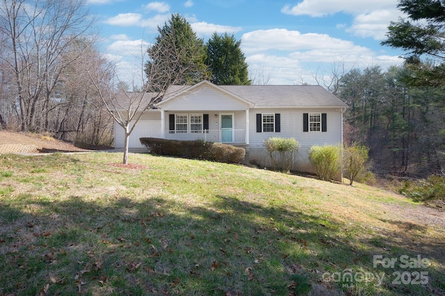 single story home with a front yard, covered porch, and a garage