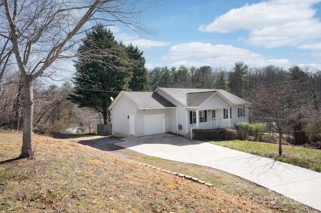 ranch-style home featuring covered porch, concrete driveway, roof with shingles, and an attached garage