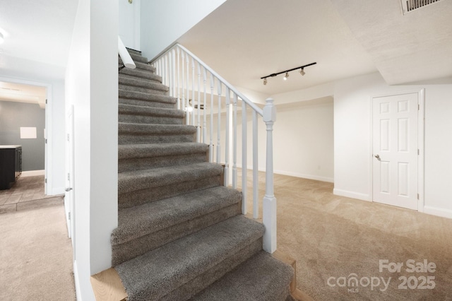 staircase featuring baseboards, carpet floors, and visible vents