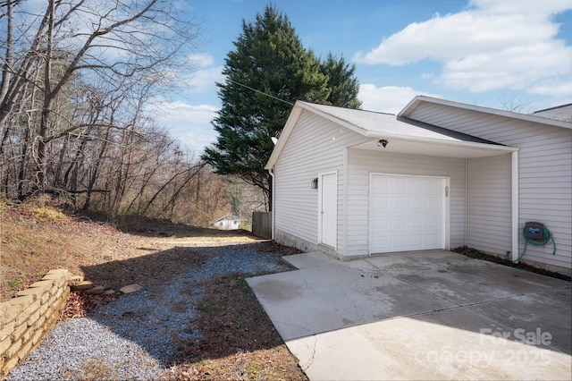 garage with concrete driveway