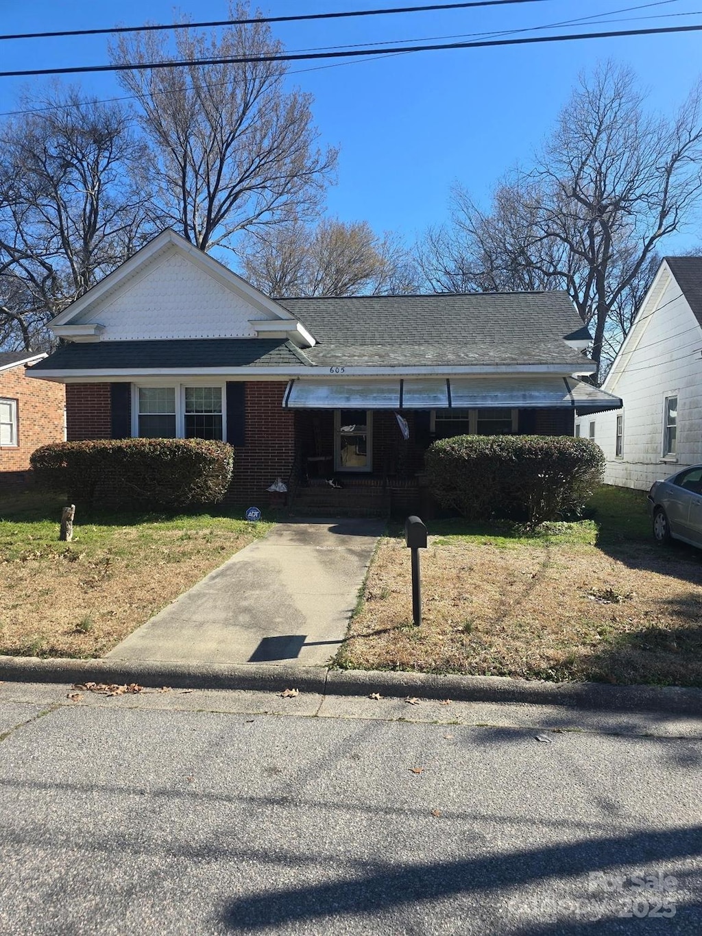 view of front facade featuring brick siding and a front lawn