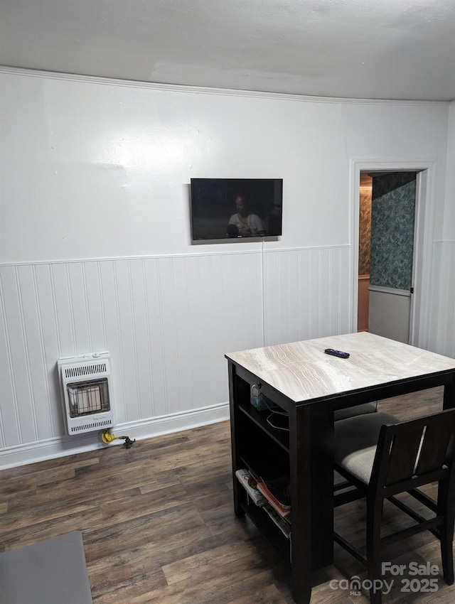 interior space with heating unit, dark wood-style floors, and wainscoting