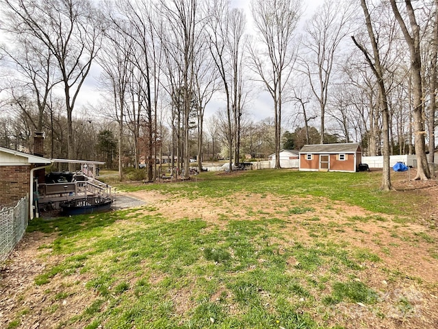 view of yard featuring an outbuilding and fence