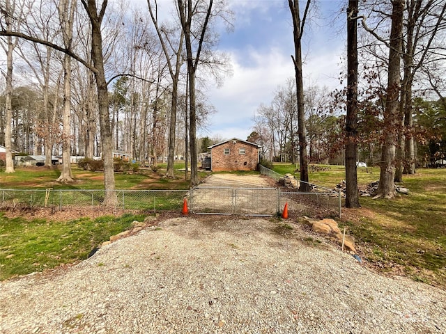 exterior space featuring a gate, gravel driveway, and fence