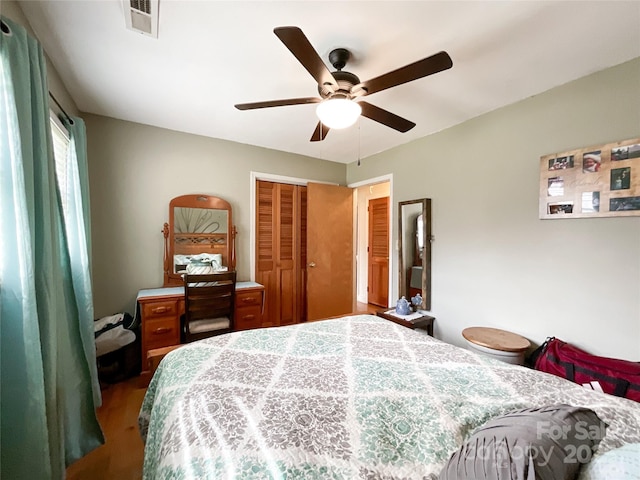 bedroom with a closet, visible vents, and a ceiling fan