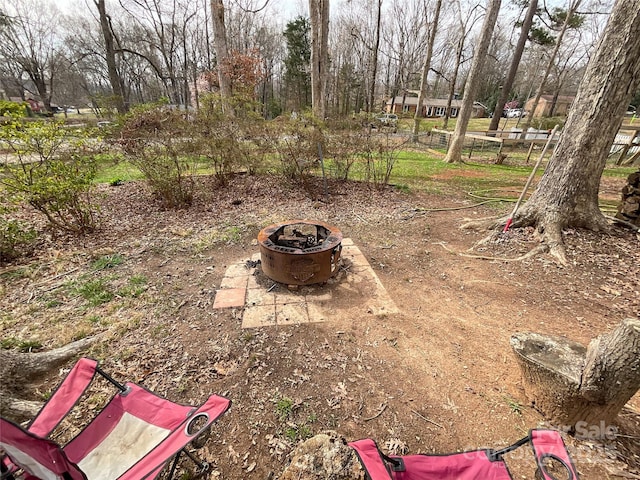 view of yard with a fire pit