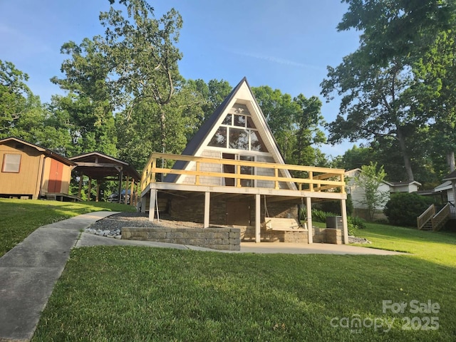 exterior space featuring a front lawn and a wooden deck