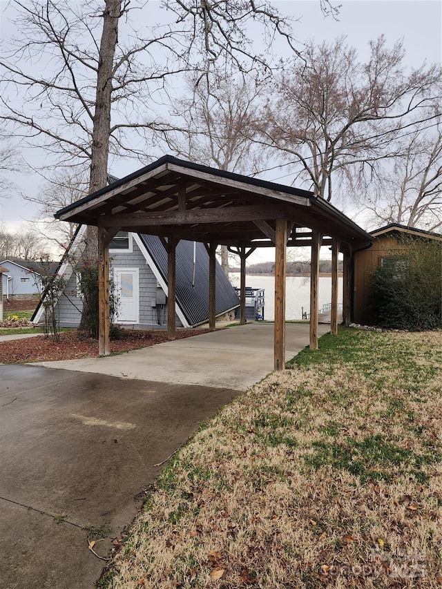 surrounding community with a detached carport and driveway